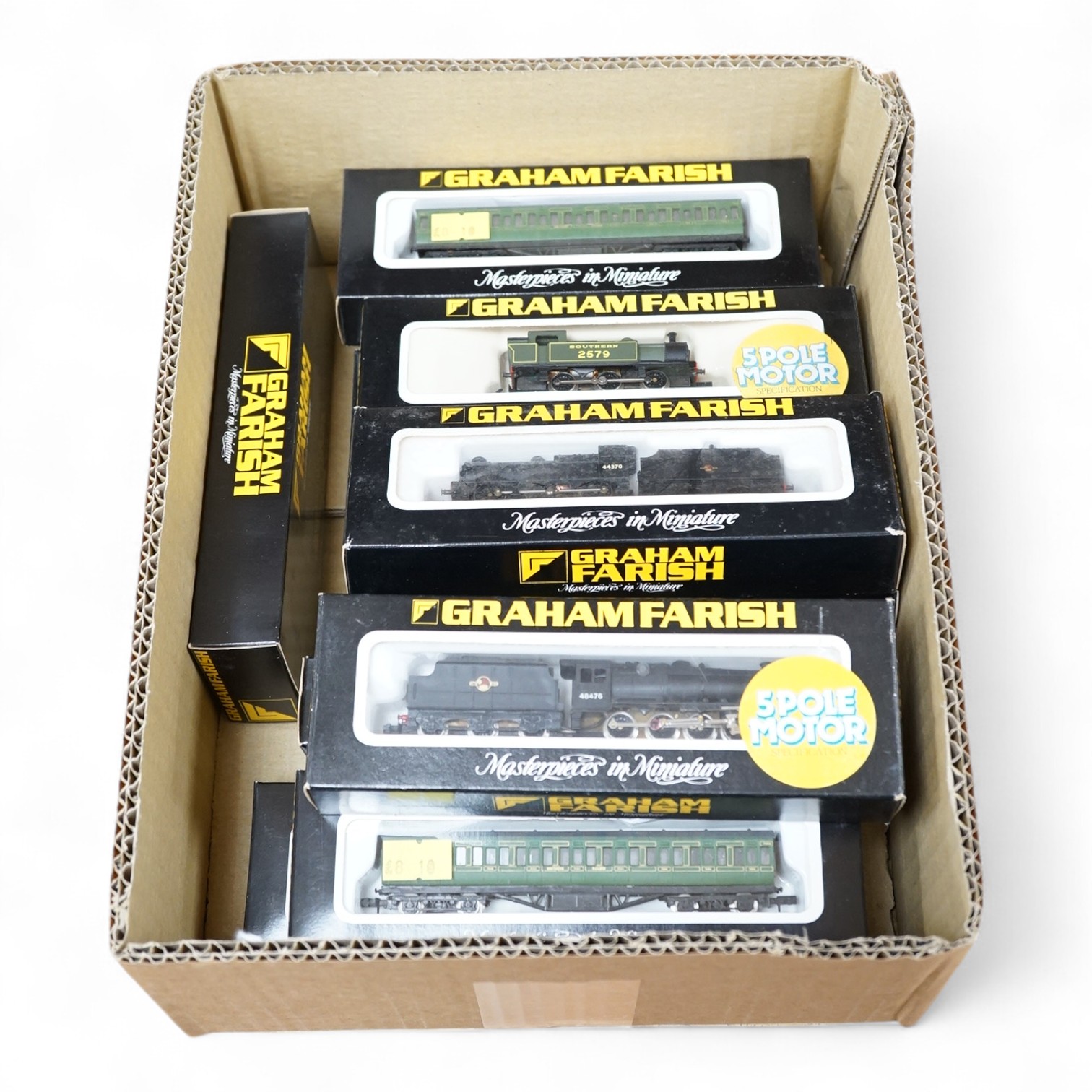 Twelve boxed Graham Farish N gauge railway, including three locomotives; an SR 0-6-0T, 2579 (1703), a BR Class 4F, 44370 (1845), and a BR Class 8F, 48476 (1905), together with nine Southern 57ft suburban coaches. Conditi
